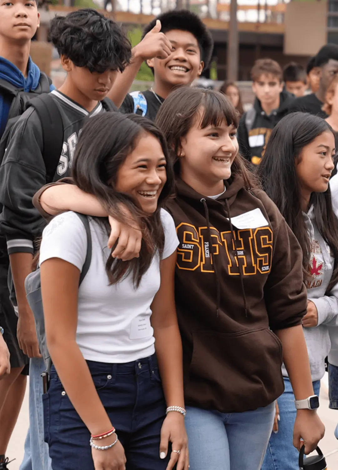 A lively group of young friends laughing and smiling, showcasing their joy and camaraderie.