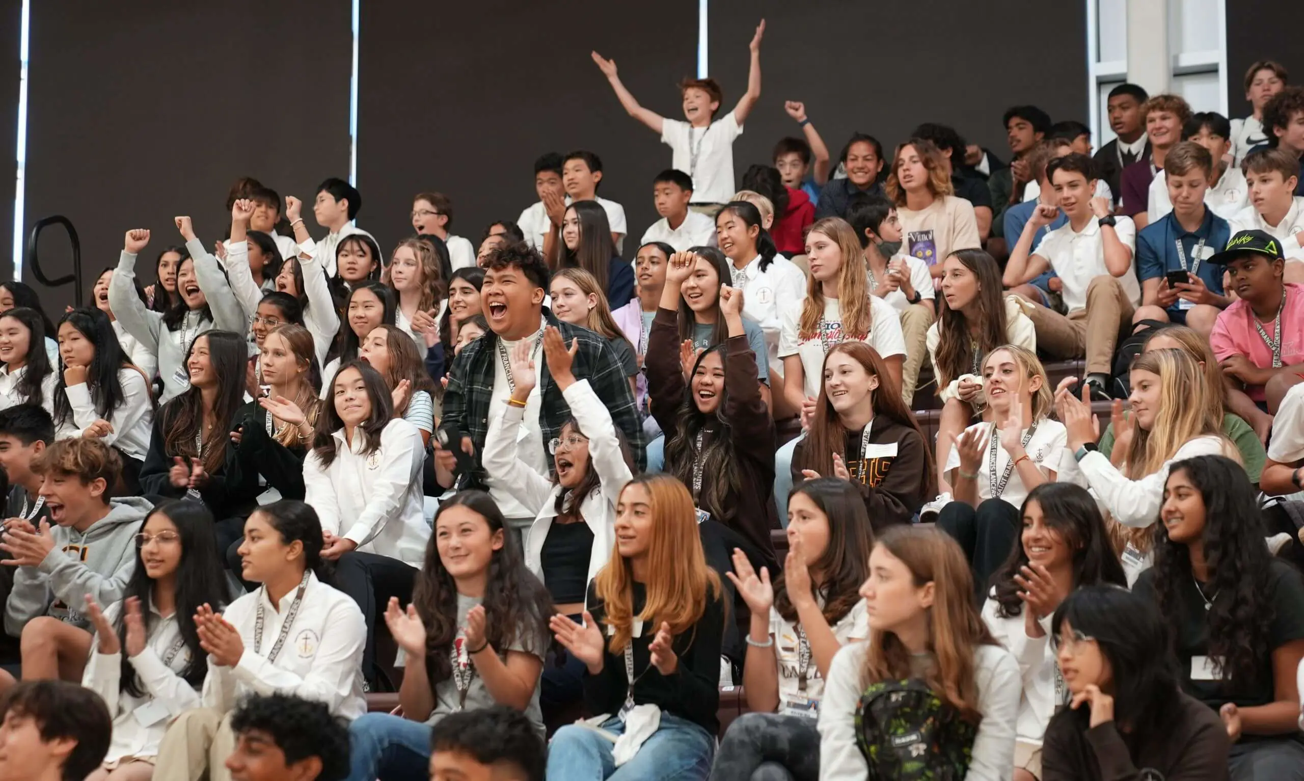 Students gathered in the gym for a rally cheering.