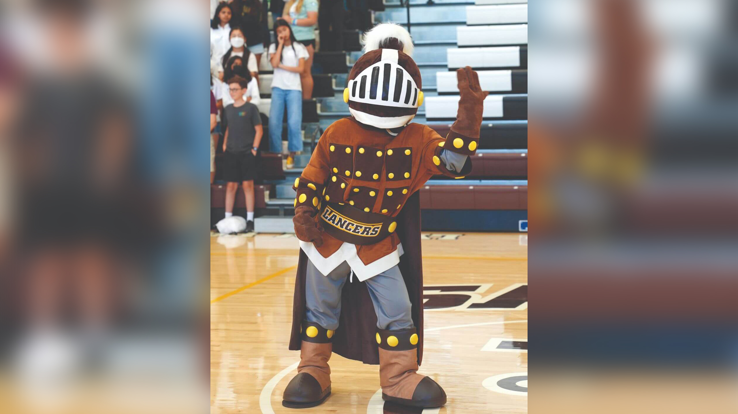 Saint Francis mascot, Lancelot, beckoning the crowd during an event.