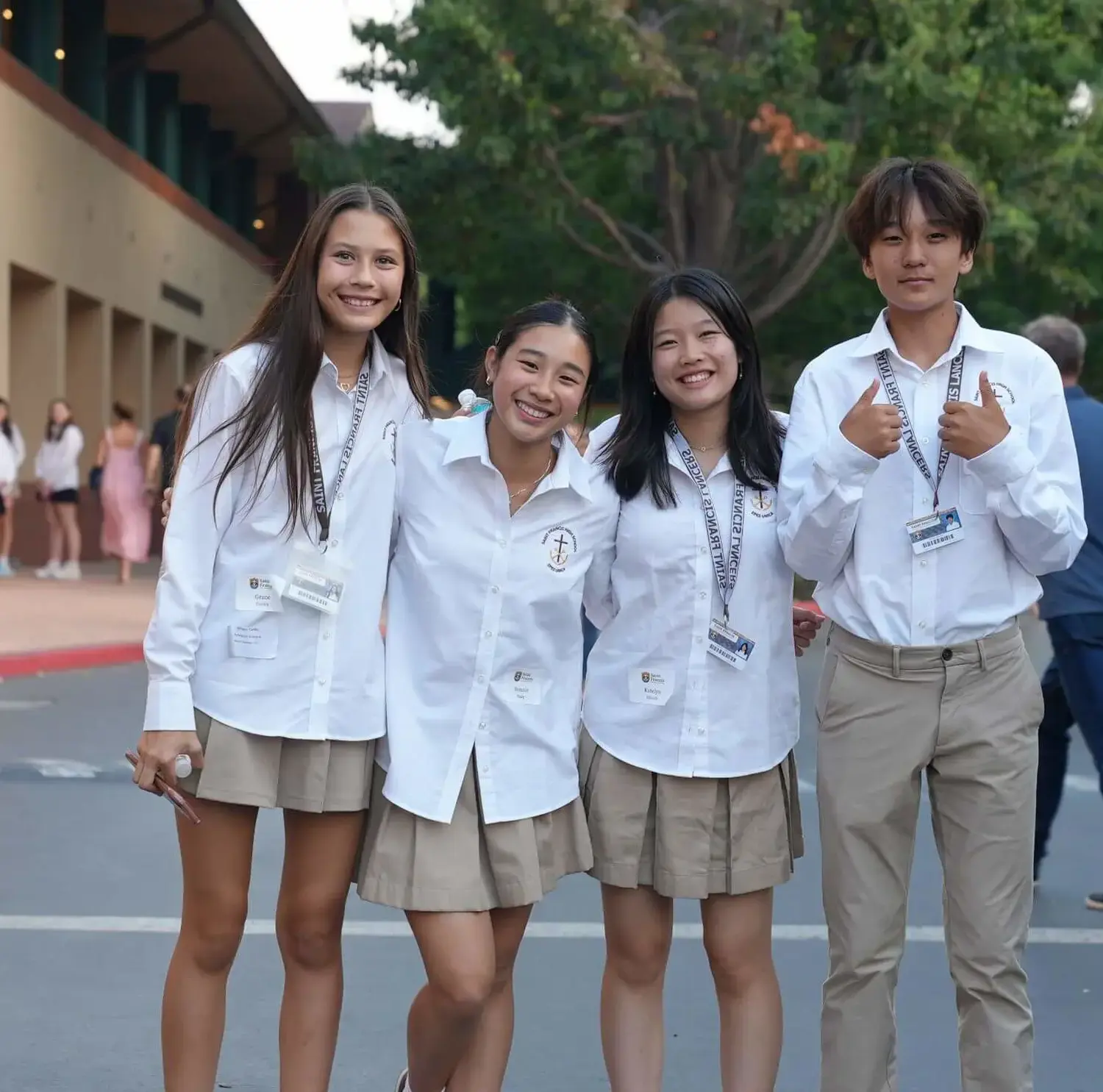 A group of Saint Francis Students welcoming you with a thumbs up.