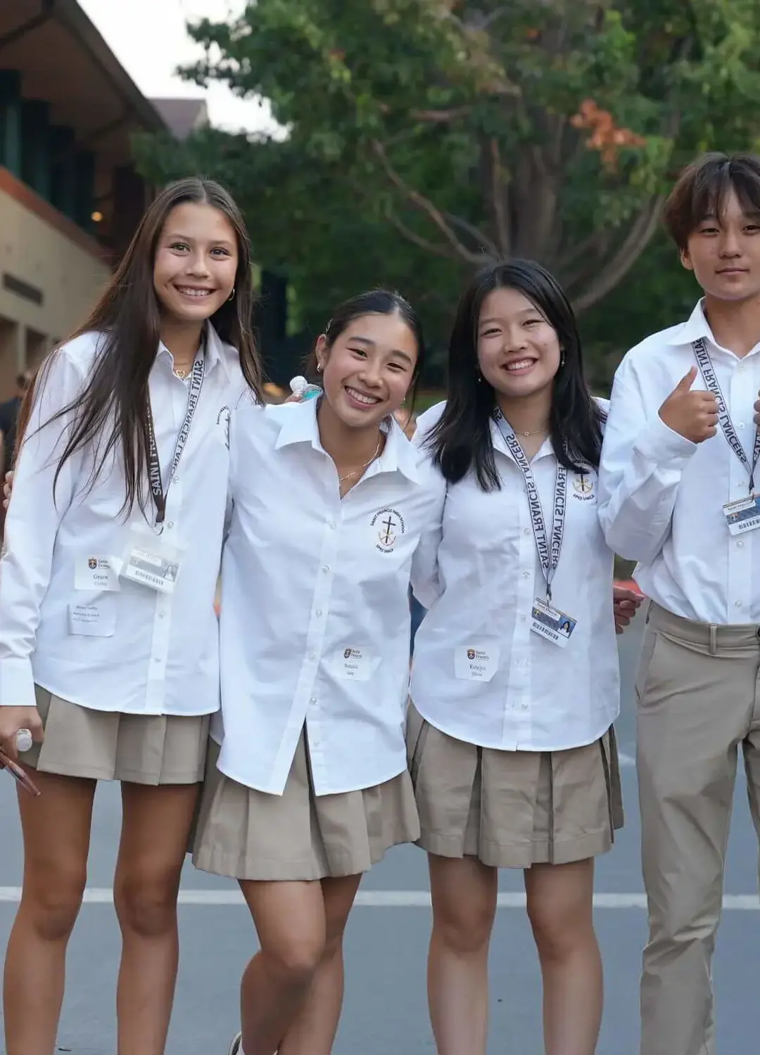 A group of Saint Francis Students welcoming you with a thumbs up.