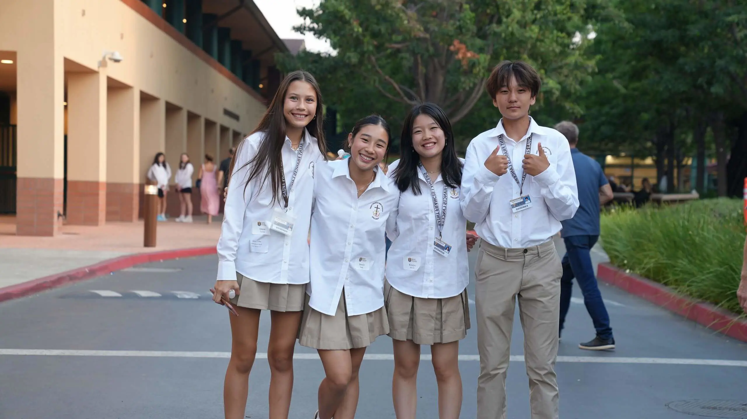 A group of Saint Francis Students welcoming you with a thumbs up.