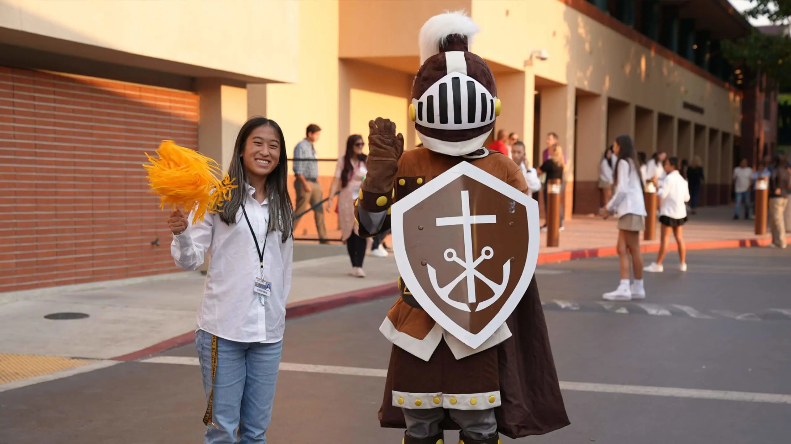 Our mascot Lancelot and a student welcome you to campus.