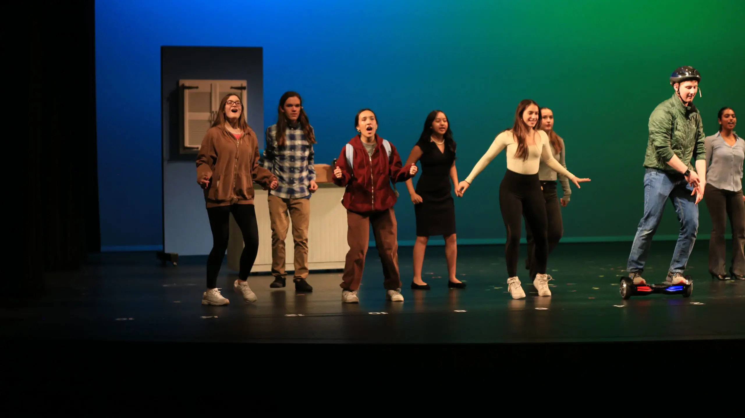 A group of students performing on stage.