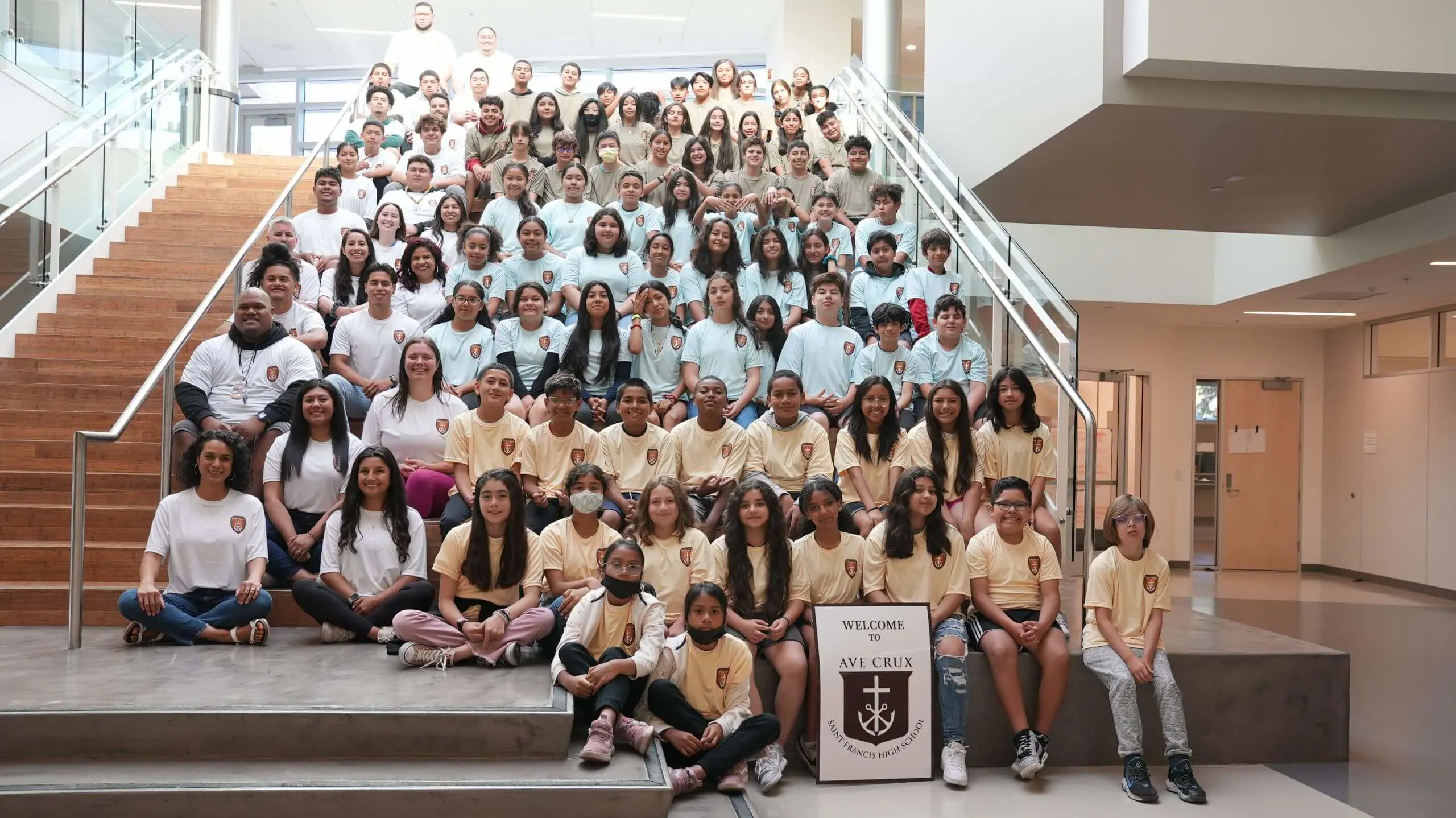 Ave Crux students sitting on the stairs of the Innovation Building. Group photo.