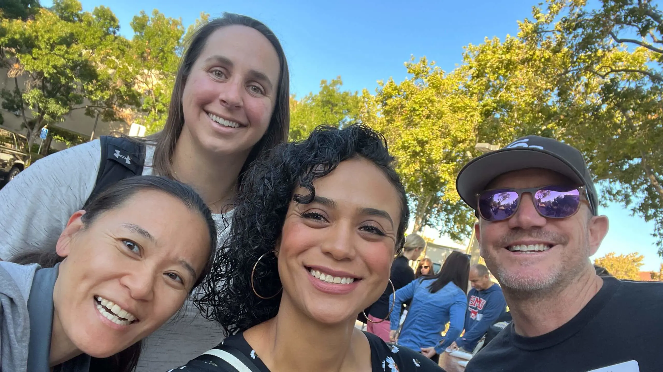 A group of educators happily taking a selfie showing their camaraderie.