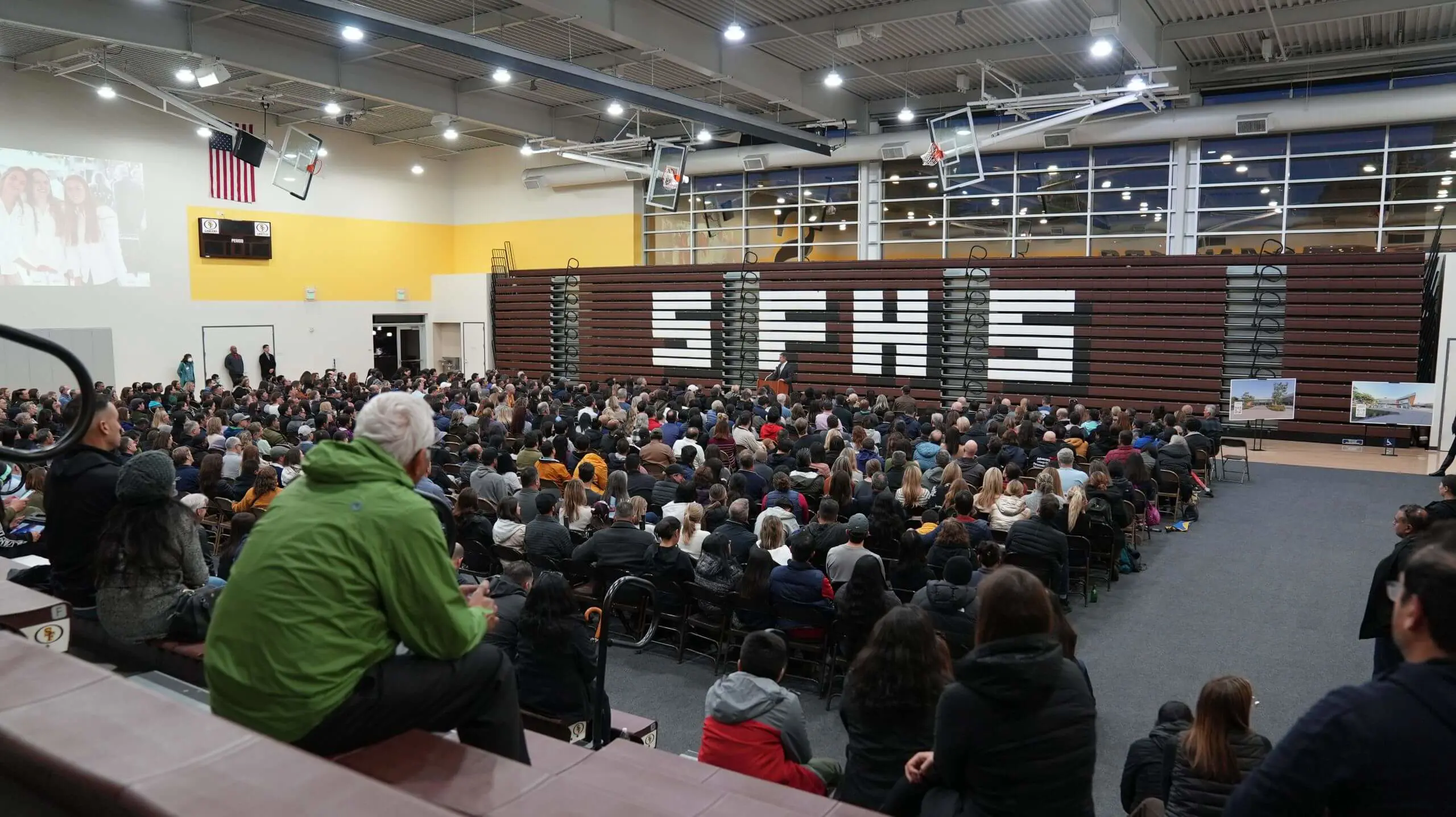 President Jason Curtis speaks to a large crowd of parents in Burns Gym.