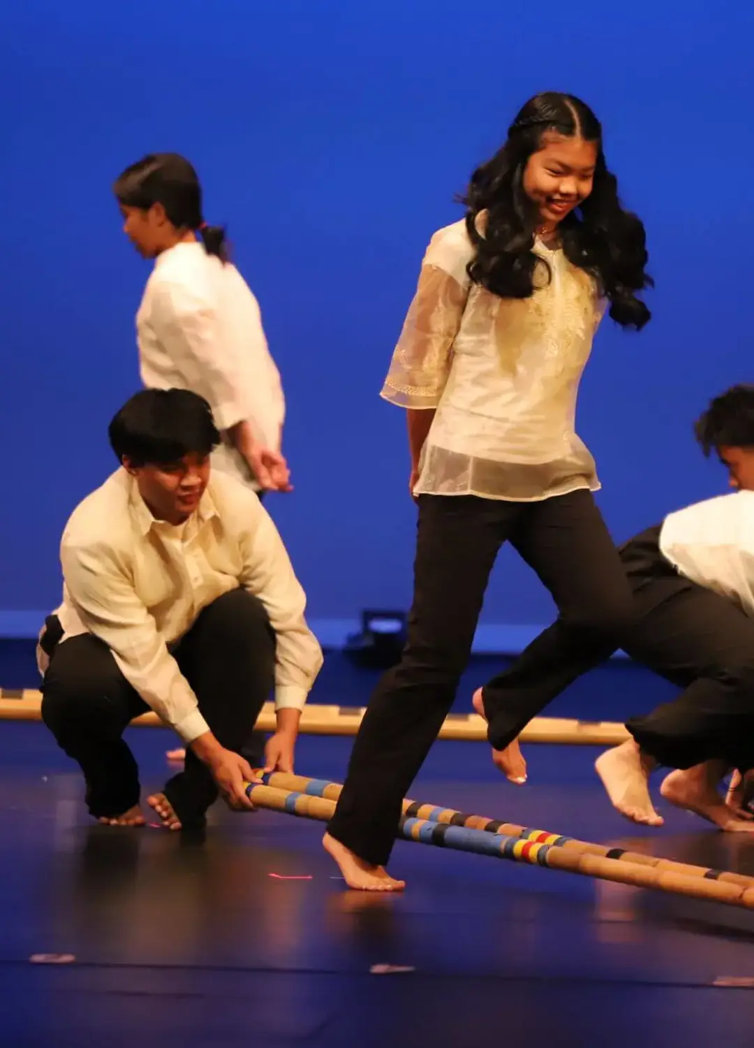 Students performing a Tinkling dance piece at a multi-cultural performance event.