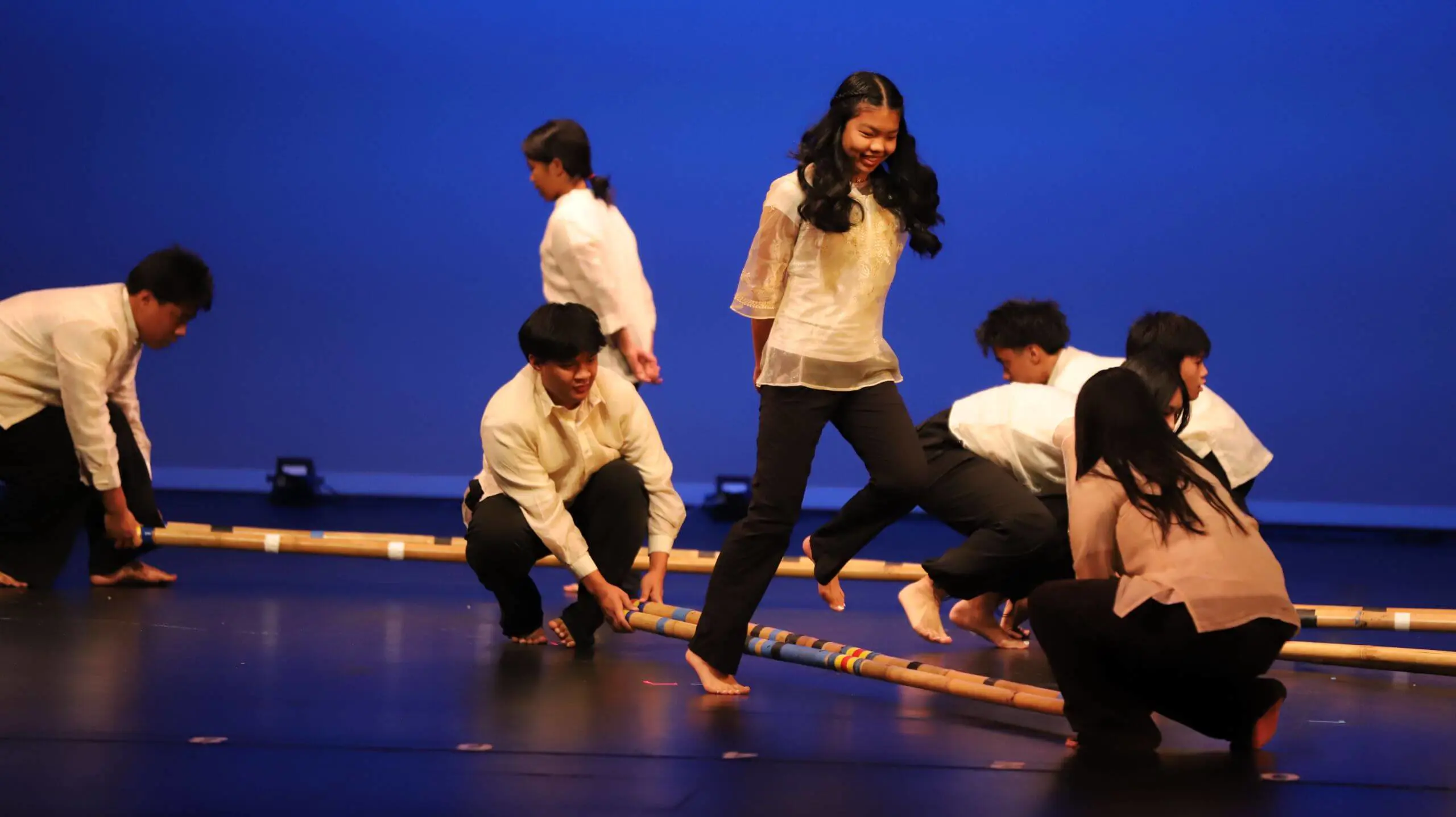 Students performing a Tinkling dance piece at a multi-cultural performance event.