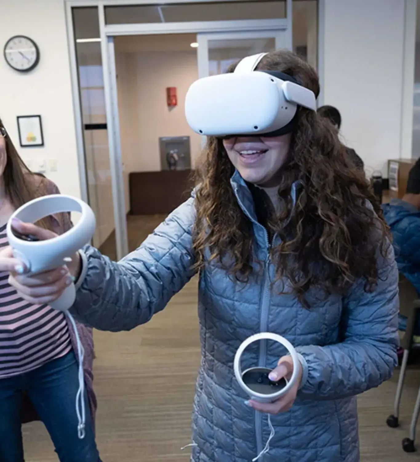 Student joyfully participating in the Flowressence VR project using an Oculus system.