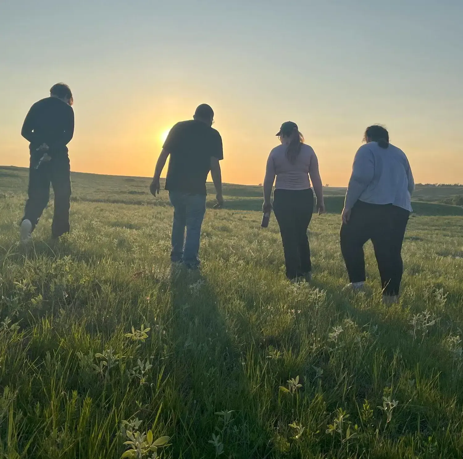Students on immersion walking on a South Dakota prairie while serving on tribal lands.