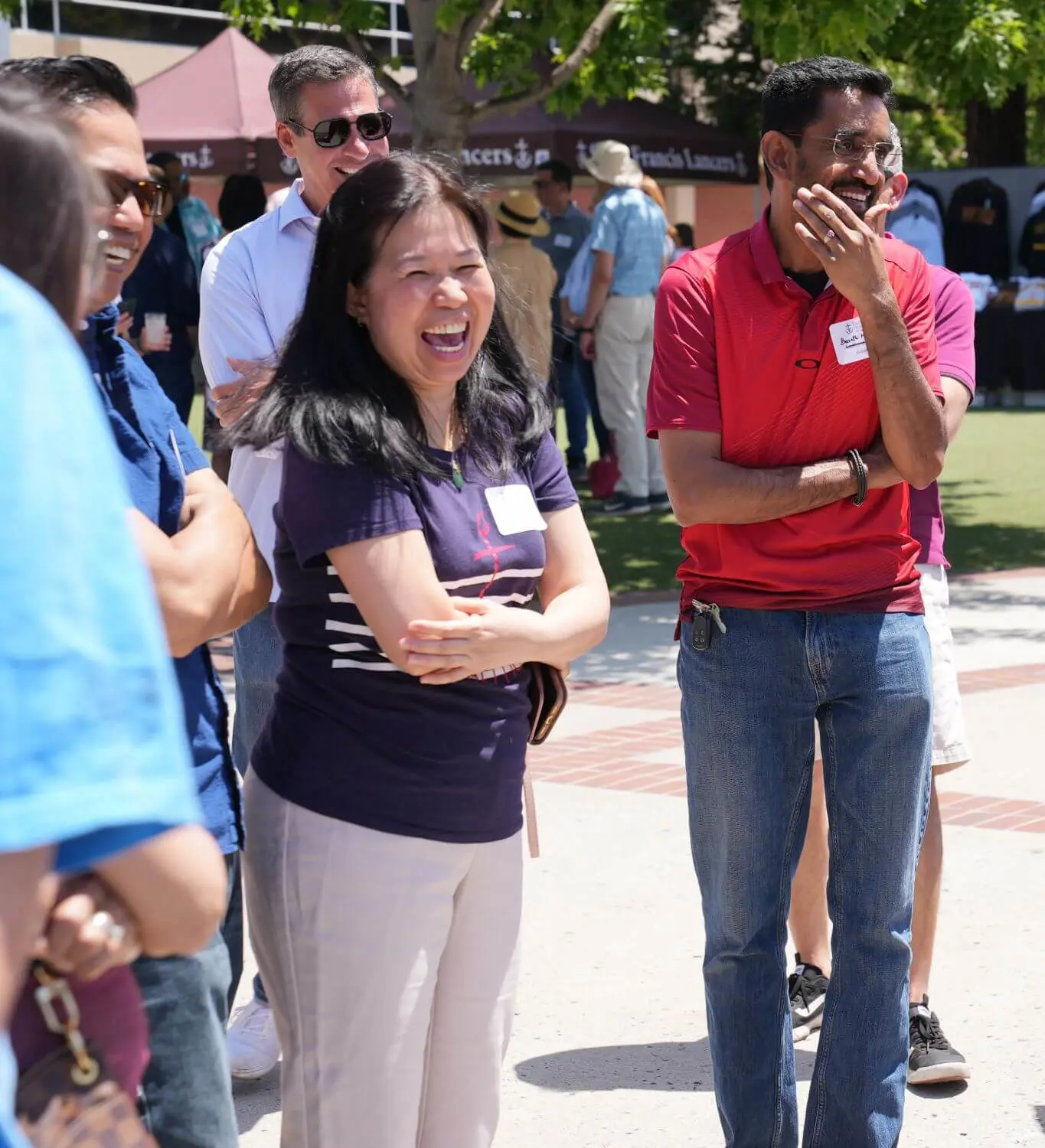 Parents laughing and getting to know each other at a back to school event.