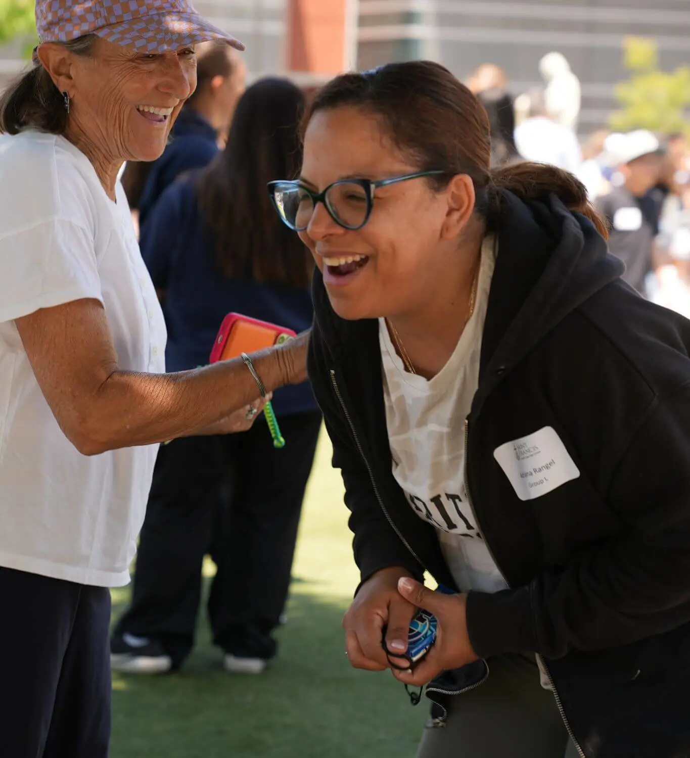 Parents having a good time and laughing as they participate in a school event.