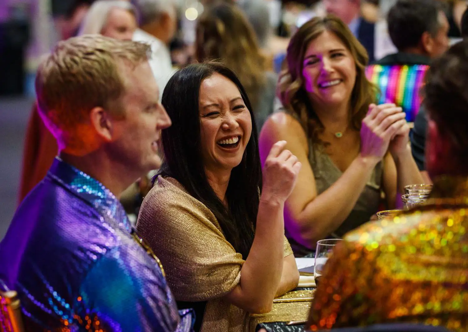 Parents enjoy themselves as they engage one another at a community event.
