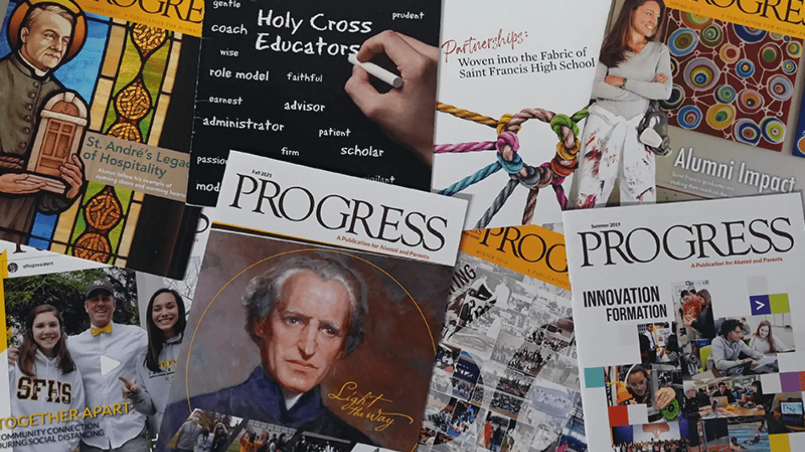 Progress magazine issues laid out on the table.