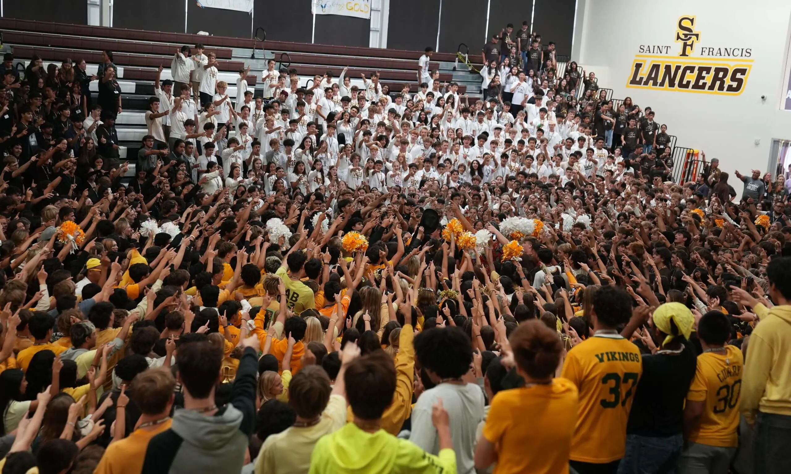 Students gathered in the gym, singing the alma mater