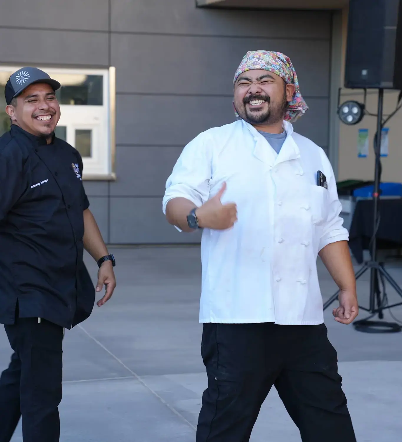 Educators smiling and giving thumbs up showcasing their camaraderie