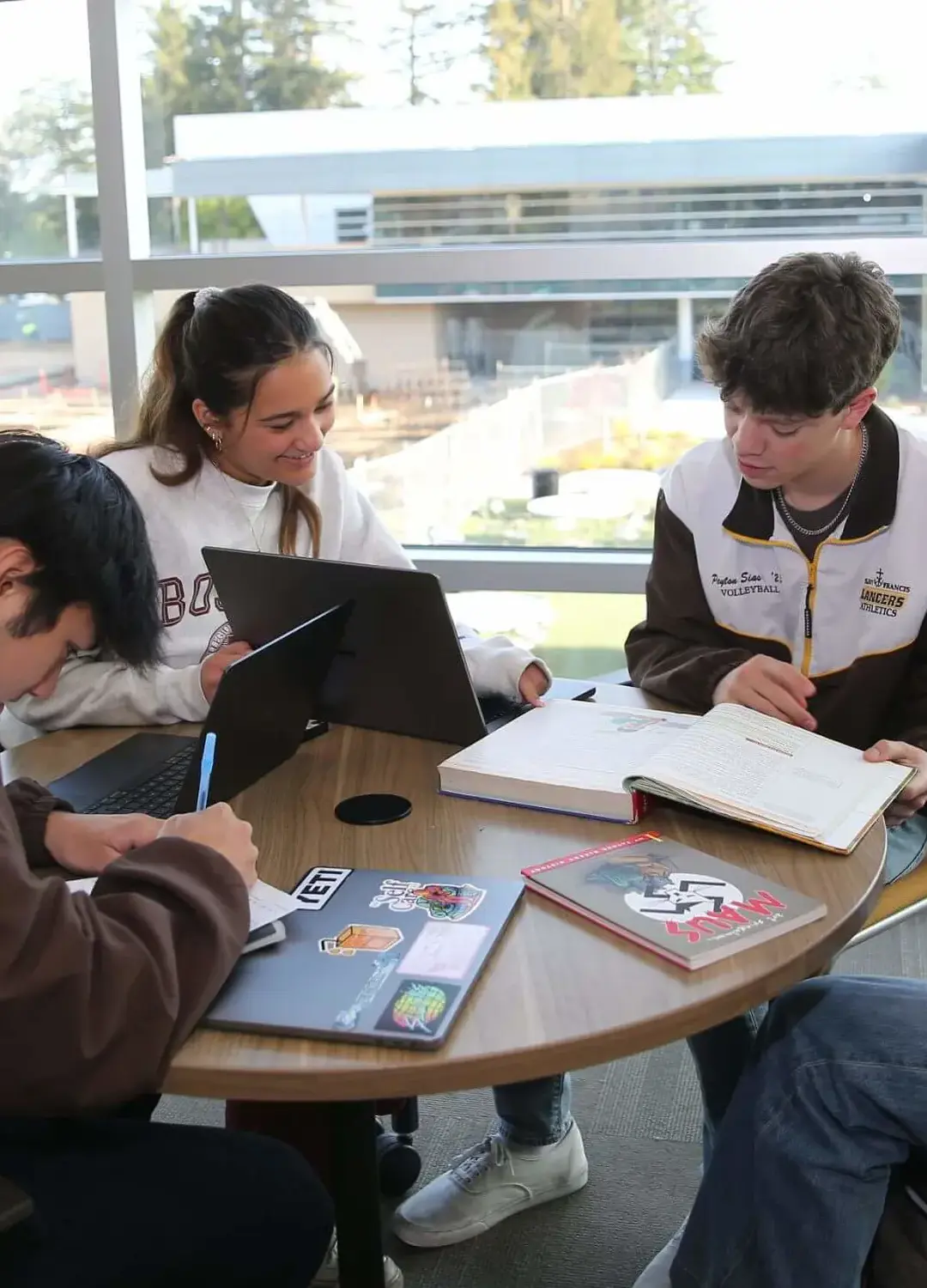 Students studying together in the Cassin Library overlooking the Quad.