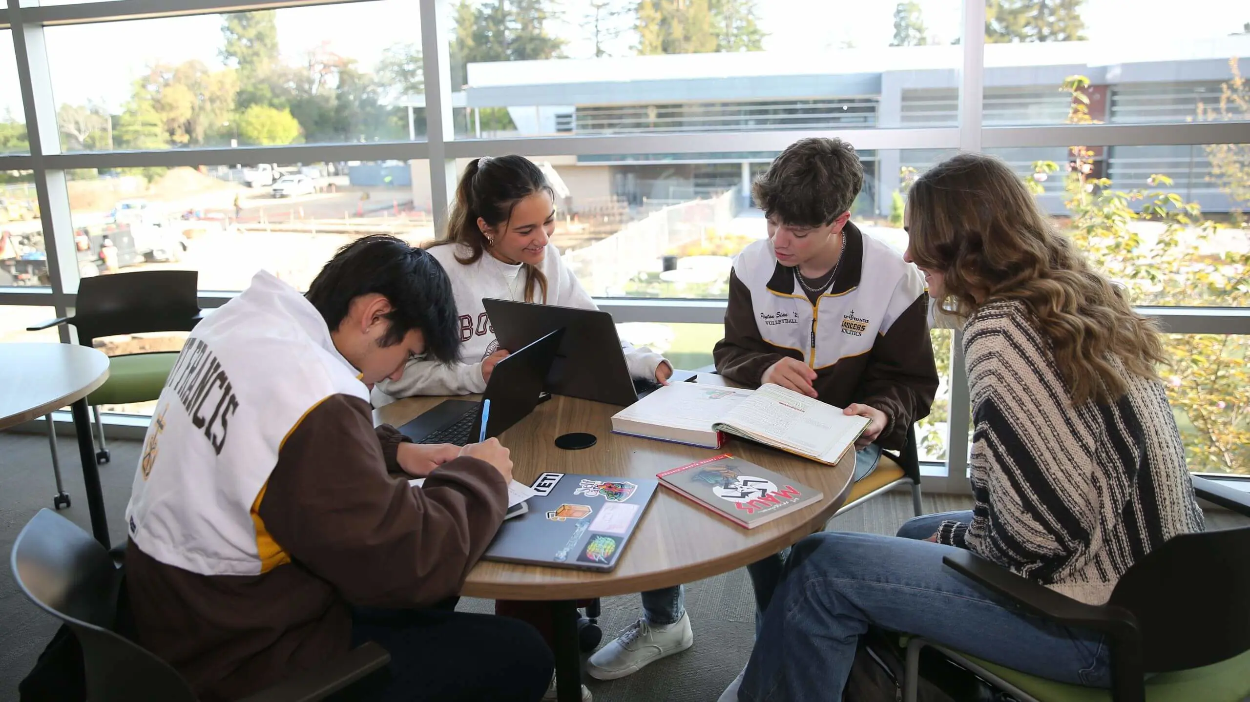 Students studying together in the Cassin Library overlooking the Quad.