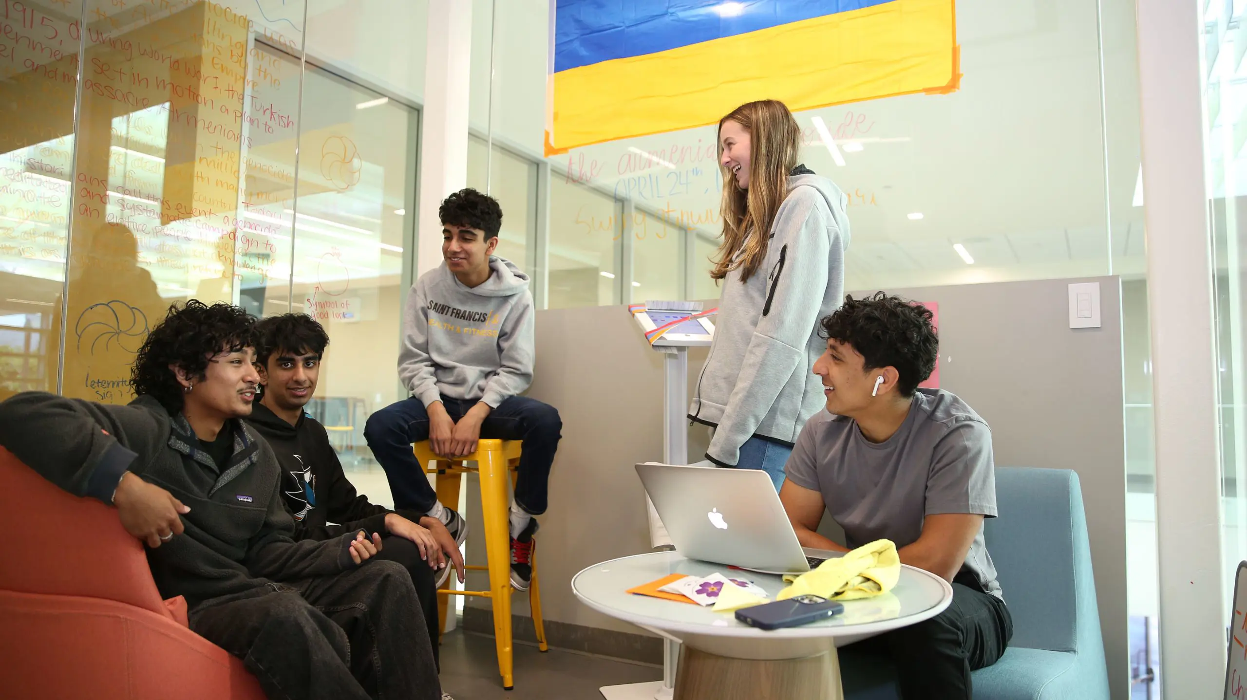 Five students gathered in the Innovation Center with an Armenian flag in the background.